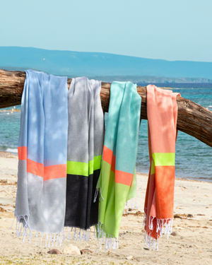 Towel to Go Neon quick-dry beach towels in a lifestyle setting.
