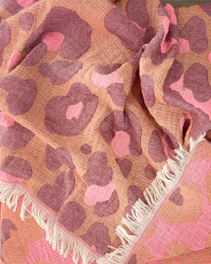 Close-up of the cotton weave and fringes of the Towel to Go Hooded Cotton Beach Poncho Camel and Rose from the Neon Safari collection.