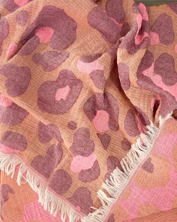 Close-up of the cotton weave and fringes of the Towel to Go Hooded Cotton Beach Poncho Camel and Rose from the Neon Safari collection.