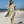 Woman using a Towel to Go Hooded Cotton Beach Poncho in Grey and Lime from the Neon Safari on the beach.