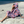 Woman using a Towel to Go Hooded Cotton Beach Poncho in Lavender and Coral from the Neon Safari on the beach 2.