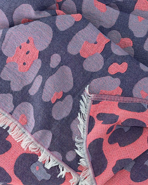 Close-up of the cotton weave and fringes of the Towel to Go Hooded Cotton Beach Poncho Lavender and Coral from the Neon Safari collection.