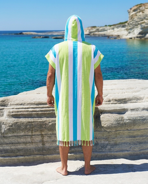 Man using a Towel to Go Hooded Cotton Beach Poncho in Blue and Lime from the Coral Coast on the beach 2.