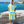 Man using a Towel to Go Hooded Cotton Beach Poncho in Blue and Lime from the Coral Coast on the beach.