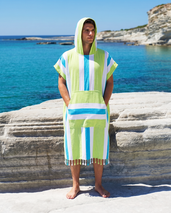 Man using a Towel to Go Hooded Cotton Beach Poncho in Blue and Lime from the Coral Coast on the beach.