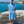 Man using a Towel to Go Hooded Cotton Beach Poncho in Blue and Navy from the Coral Coast on the beach.