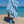 Woman using a Towel to Go Quick Dry Cotton Towel in Blue and Navy from the Color Coast on the beach.