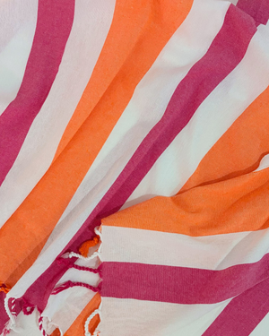 Close-up of the cotton weave and fringes of the Towel to Go Quick Dry Cotton Towel Orange and Fuchsia from the Coral Coast collection.