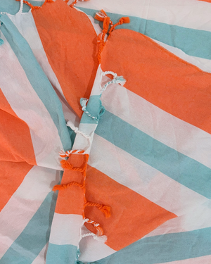 Close-up of the cotton weave and fringes of the Towel to Go Quick Dry Cotton Towel Orange and Mint from the Coral Coast collection.