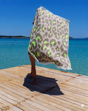 Woman using a Towel to Go Quick Dry Cotton Towel in Grey and Lime from the Neon Safari on the beach 2.