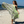 Woman using a Towel to Go Quick Dry Cotton Towel in Grey and Lime from the Neon Safari on the beach.