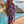 Woman using a Towel to Go Quick Dry Cotton Towel in Lavender and Coral from the Neon Safari on the beach 3.
