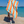 Woman using a Towel to Go Quick Dry Cotton Towel in Orange and Mint from the Coral Coast on the beach.