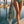 Woman using a Towel to Go Quick Dry Cotton Towel in Sage and Blush from the Neon Safari on the beach 3.
