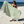 Woman using a Towel to Go Quick Dry Cotton Towel in Sage and Blush from the Neon Safari on the beach.